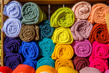 Echarpes multicolores en laine, enroulées.	