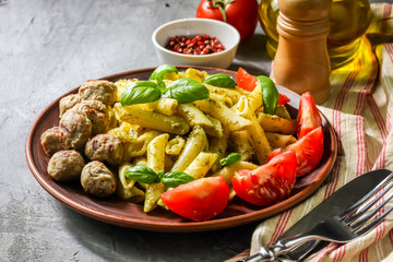 Pasta with pesto sauce and meatballs