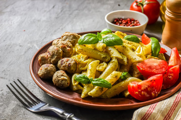 Pasta with pesto sauce and meatballs