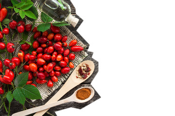 bunch branch Rosehips, types Rosa canina hips, essential oil. Medicinal plants and herbs composition 