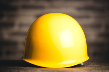 レンガ背景と黄色いヘルメット