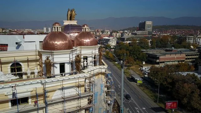Drone shot of statues on top of new luxurious building in central Skopje, part of a highly criticized government program in Macedonia