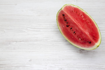Top view fresh cut watermelon on a white wooden background. Space for text.