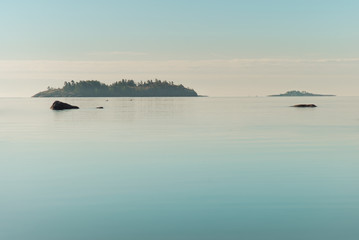 Seascape. Several islands in the sea. Full calm