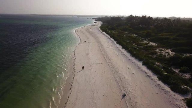 Long beach in Africa/Kenya and beautiful colorfull water filmed by a drone