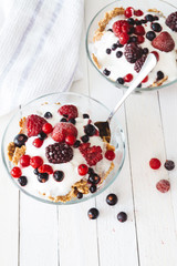 Granola with yogurt, strawberries, blackberries and blueberries