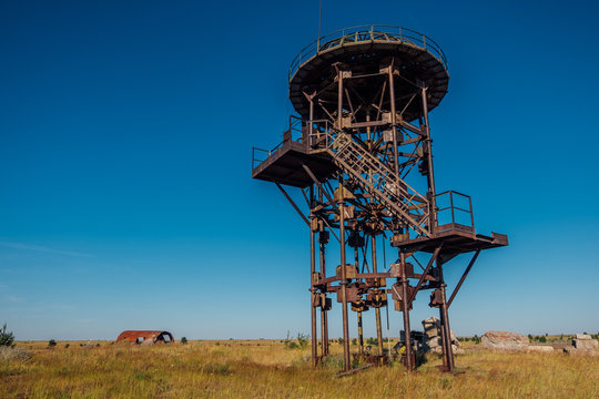 Old rusty iron abandoned watch tower in wastelands  - Powered by Adobe