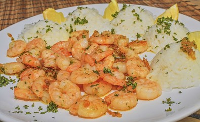 Grilled prawns and cooked rice with slices of lemon and chopped basil. Food photography.  Bio healthy recipe