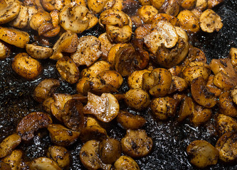 fried mushrooms champignons halves of vegetables hats appetizing delicious lunch close-up