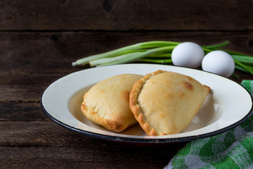 Homemade pies with egg, onion and chicken.