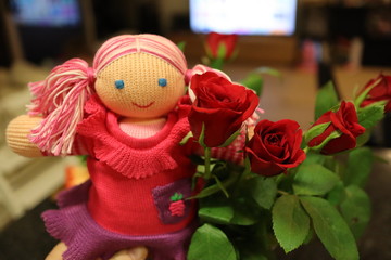 A red doll in red flowers