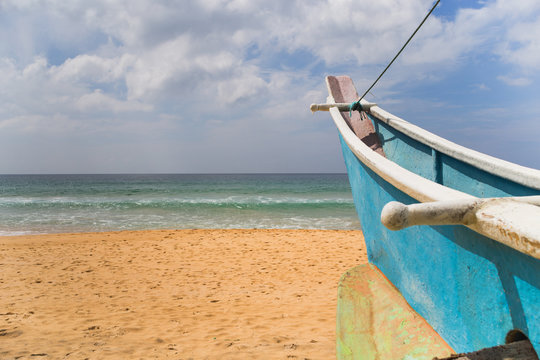 Image of boat at the beach in Sri Lanka.