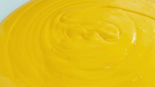 Yellow Paint Pours On Surface