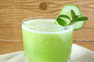 
green juice garden fresh cucumber juice on wooden background