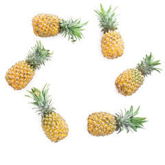 Round frame of pineapple fruits on white background. Flat lay, top view. Food concept with copy space