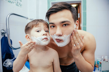 Dad teaches his son to shave