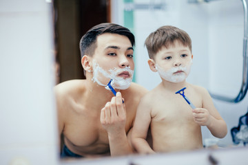 Dad teaches his son to shave