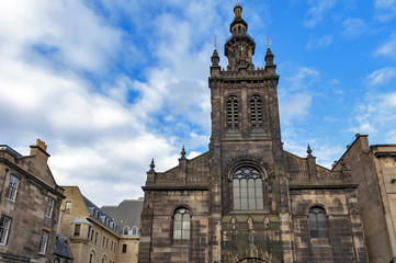 Fototapeta na wymiar Front facade of Augustine Church Centre in Edinburgh, Scotland, showing a mixture of Romanesque, Renaissance and Classical architecture topped by a three-tiered tower