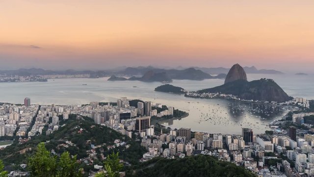 Sunset over Rio de Janeiro skyline with Sugarloaf Mountain, Brazil. Panning Time Lapse
