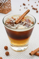 coffee cocktail on the table decorated with a stick of cinnamon