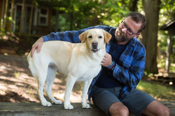 Man and yellow lab dog camping