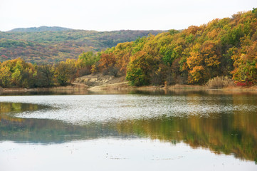 Autumnal landscape with lake and hills