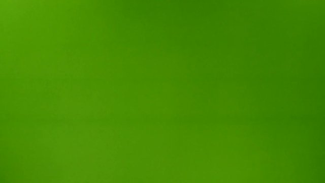 Male hand holding hammer on green background