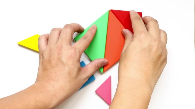 Man complete tangram puzzle in rocket or missile shape on white background (Concept for exploration, new experience,start up business)