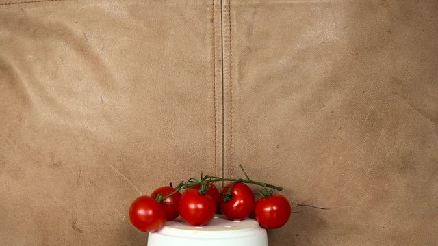tomatoes plased on white column