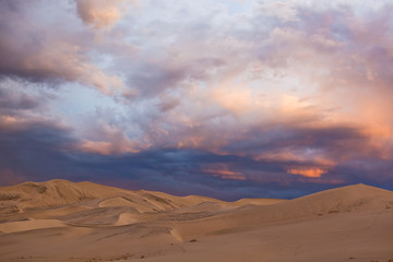 Storm Clouds Passing Over Desert Sand Dunes