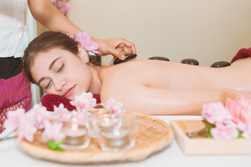 Fototapeta na wymiar Thai Spa therapy on the girl lay on bed with many item around, spa and massage concept