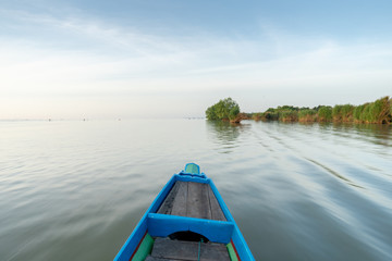 Long tail boat head view fast sailing moving fast