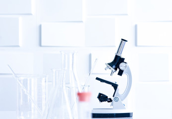 Microscope and glass apparatuses in laboratory for use to analyse in microbiology and chemical