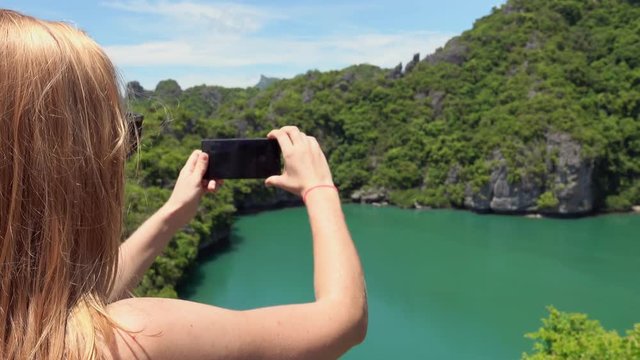 Young Female Tourist Taking Photo of Emerald Lake in Angthong National Marine Park in Thailand on Mobile Phone