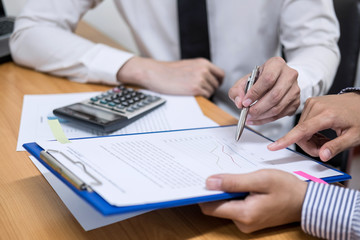 Two business team working and discussing Financial investment on report with calculate Analyze business and market growth on financial document data graph