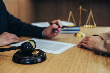 Marriage divorce on Judge gavel deciding, Consultation between a Businesswoman and Male lawyer or...
