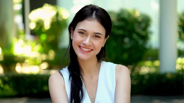 Beautiful woman smiling while waving hand and send kisses