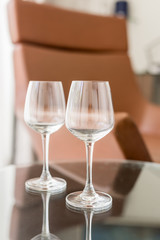 Two glasses on the table. Vertical. Hotel.