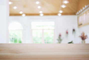 Empty wooden table and blurred background of abstract in front of coffee shop or restaurant for display of product or for montage