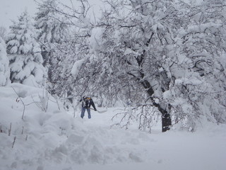 Man shoveling snow in a heavy blizzard