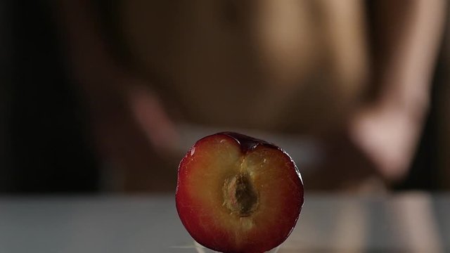 close-up half peach, woman takes off and puts on her panties. imitation vagina. slow motion