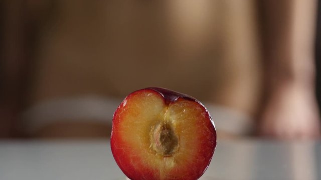 close-up half peach, woman takes off and puts on her panties. imitation vagina. 4K