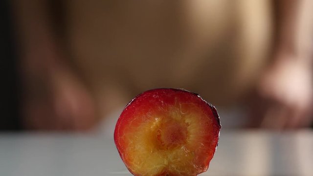 close-up half peach, woman takes off and puts on her panties. imitation vagina. 4K