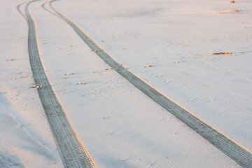 Off road tyre tracks on sand in outskirt of town