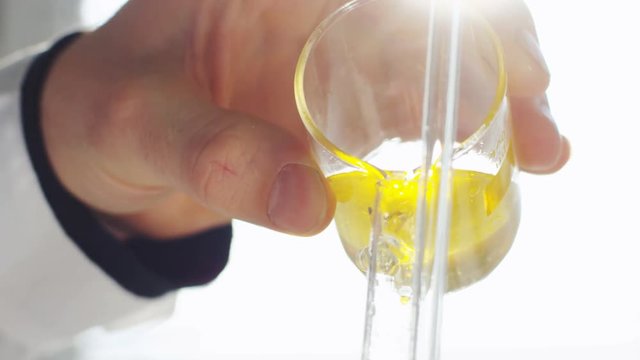 yellow liquid produced from oil in laboratory glass