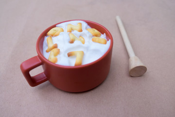 A cup of hot milk with biscuit