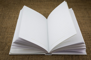 White book on sackcloth textured brown