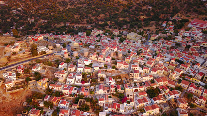 Aerial birds eye view photo taken by drone of Yalos, iconic port of Symi island at sunset with beautiful clouds, Dodecanese, Greece