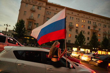 Russian people celebrating on the streets victory of the football national team during the world cup in moscow with flags
