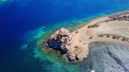 Aerial birds eye view photo taken by drone of famous rock of Kalikatsou in Petra beach, Patmos island, Dodecanese, Greece